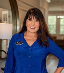 Smiling woman in blue shirt indoors