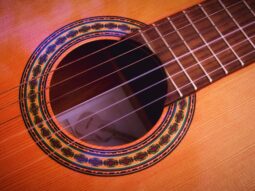 closeup photography of brown acoustic guitar